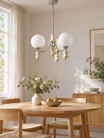 Cream three-light rod chandelier in dining room