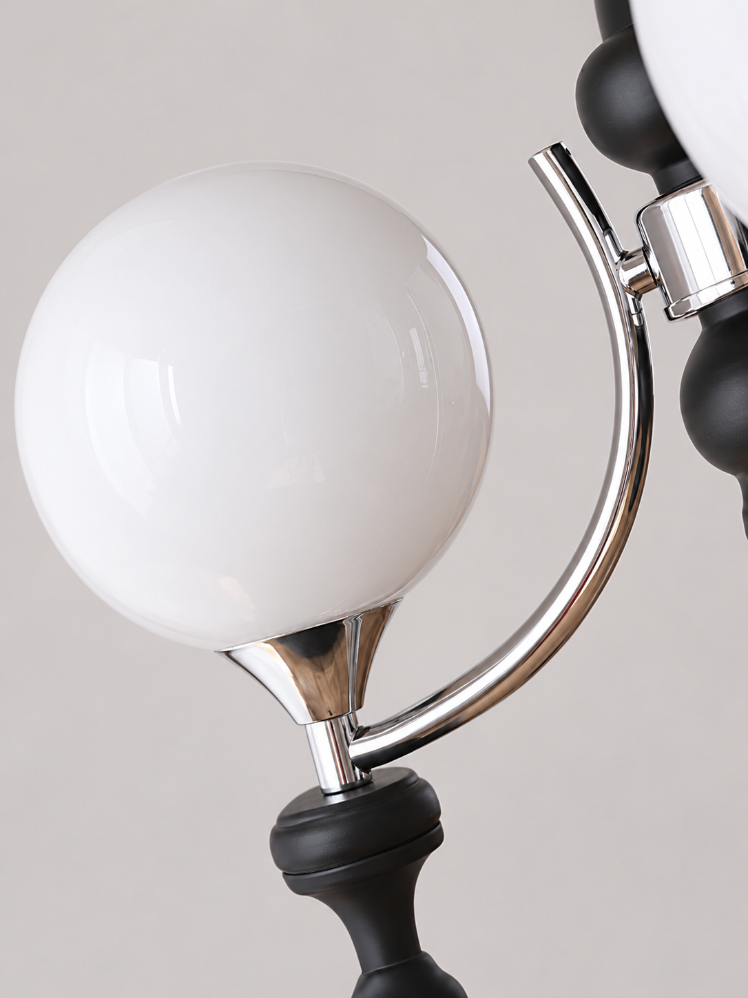Chrome arm and white glass globe detail