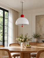 Red dome pendant in dining room, unlit