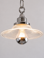 Close-up of chrome socket, prismatic glass shade and half-silvered bulb
