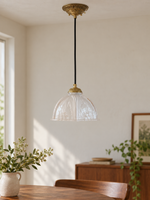 Copper-Tone pendant with translucent patterned glass dome, shown unlit, daylight dining-room setting