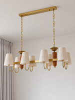 8-light linear chandelier, full product view, unlit pleated fabric shades and copper-color hardware