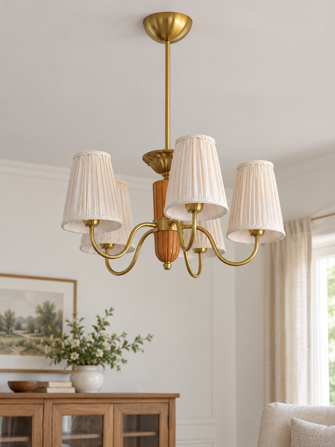 5-light round chandelier in a daylight living room, unlit pleated fabric shades and copper-color hardware