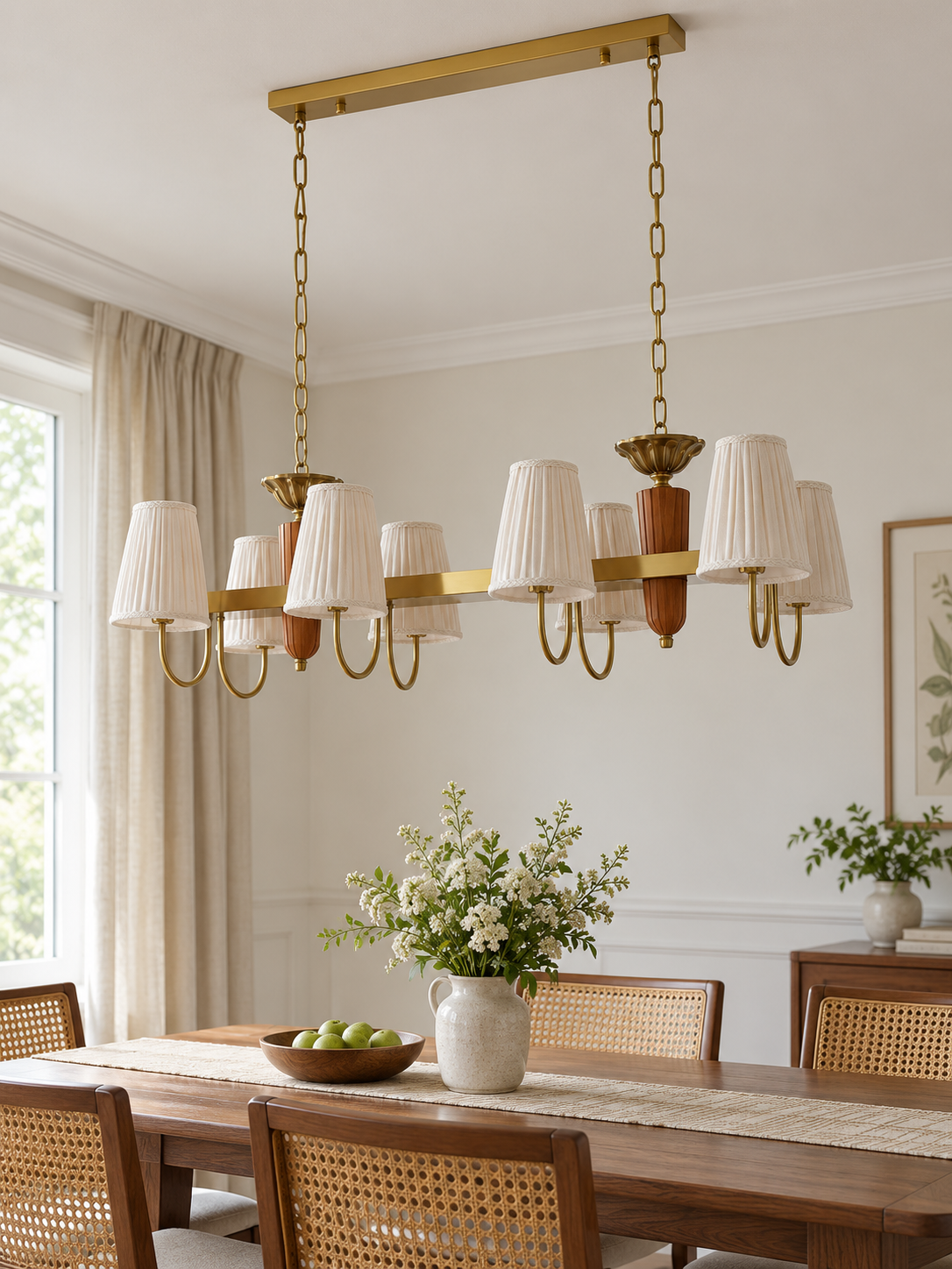 8-light linear chandelier in a daylight dining room, unlit pleated fabric shades and copper-color hardware