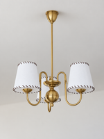 Copper-tone chandelier with 3 white stitched fabric shades, shown unlit, product view