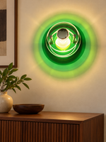 Green layered acrylic disc wall sconce in an interior setting; demonstration bulb not included