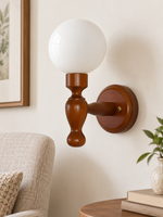 White Glass turned-wood wall sconce, hardwired, in a daylight reading corner