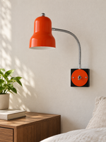 Orange gooseneck wall light in an interior setting