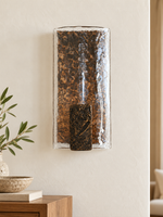Copper-toned textured-glass wall sconce in a daylight reading corner