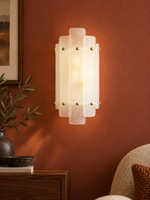 Tiered seeded-glass wall sconce in a warm reading corner