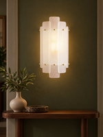 Tiered glass wall sconce in an olive hallway