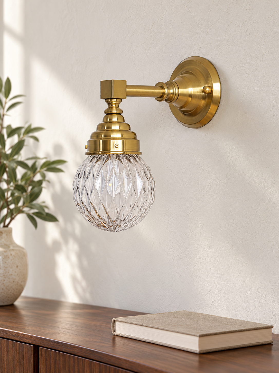 Copper-tone diamond-globe wall light with clear glass in an interior setting