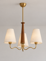 Three-light chandelier with copper-toned curved arms and ivory fabric shades