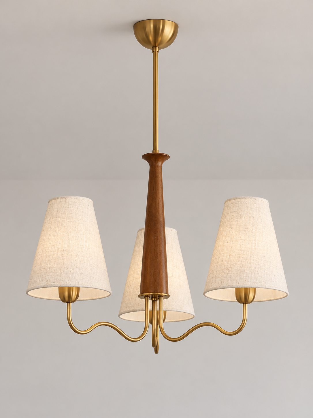 Three-light chandelier with copper-toned curved arms and ivory fabric shades