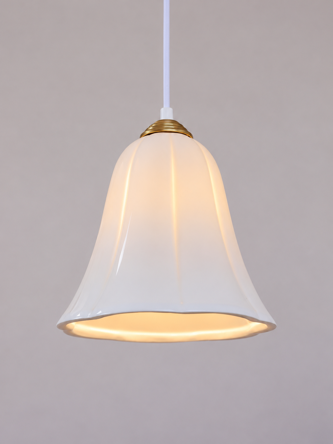 Copper-tone cap and glossy ceramic bell shade detail