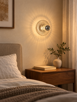 Fluted clear glass rosette wall light in a warm bedside interior