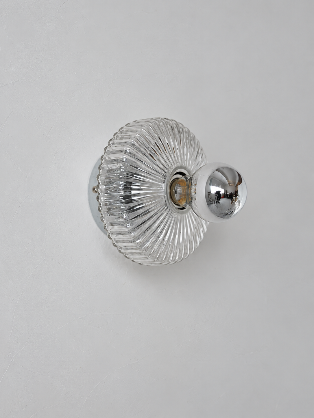 Unlit clear glass and chrome-tone socket detail