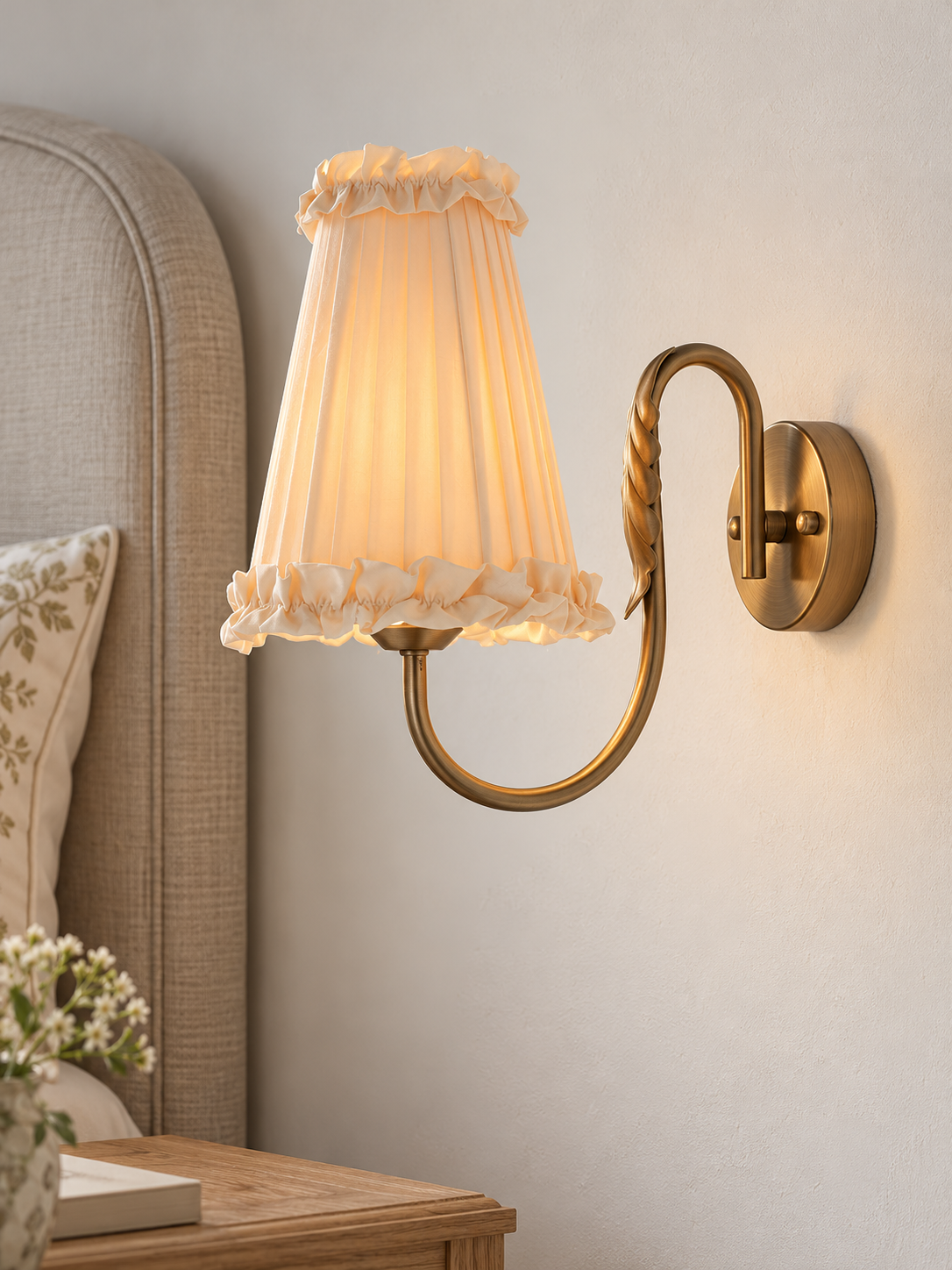 Wheat Scroll fabric wall sconce in Copper Tone with wall-switch control beside a linen headboard