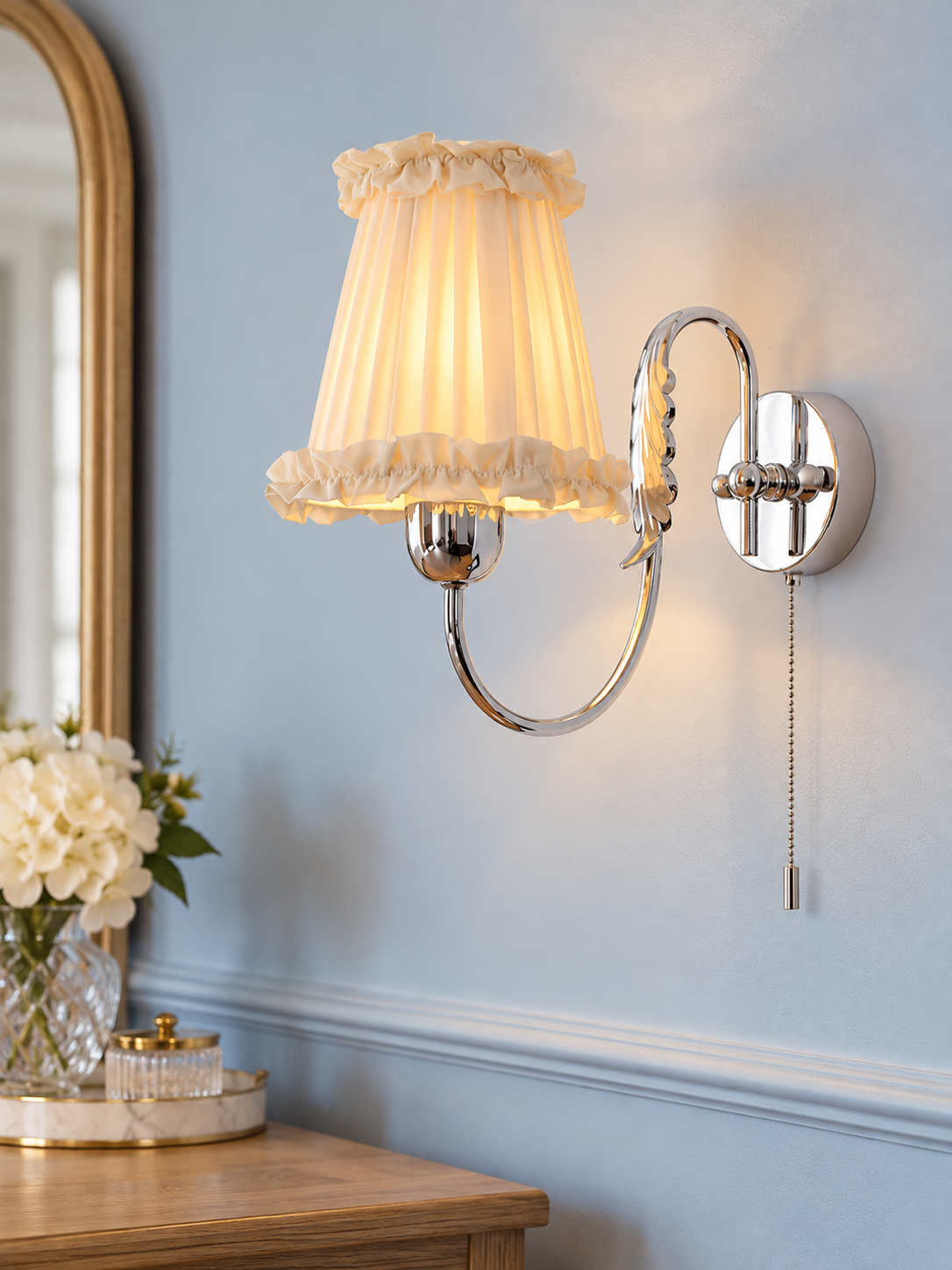 Wheat Scroll fabric wall sconce in Chrome with a pull-cord switch on a pale blue wall