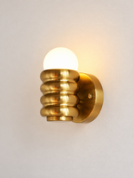 Copper-tone rounded rib iron wall light with globe bulb