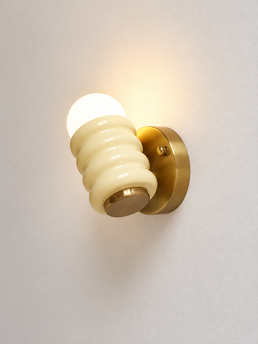 Underside angle of cream ribbed iron wall light