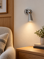 Compact Chrome Cone Wall Spotlight in a reading nook