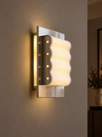 Wave Frame paper wall sconce glowing on a taupe wall at evening