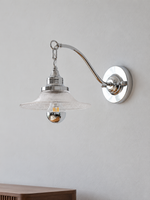 Clear Arc wall sconce in chrome and clear glass, unlit three-quarter view