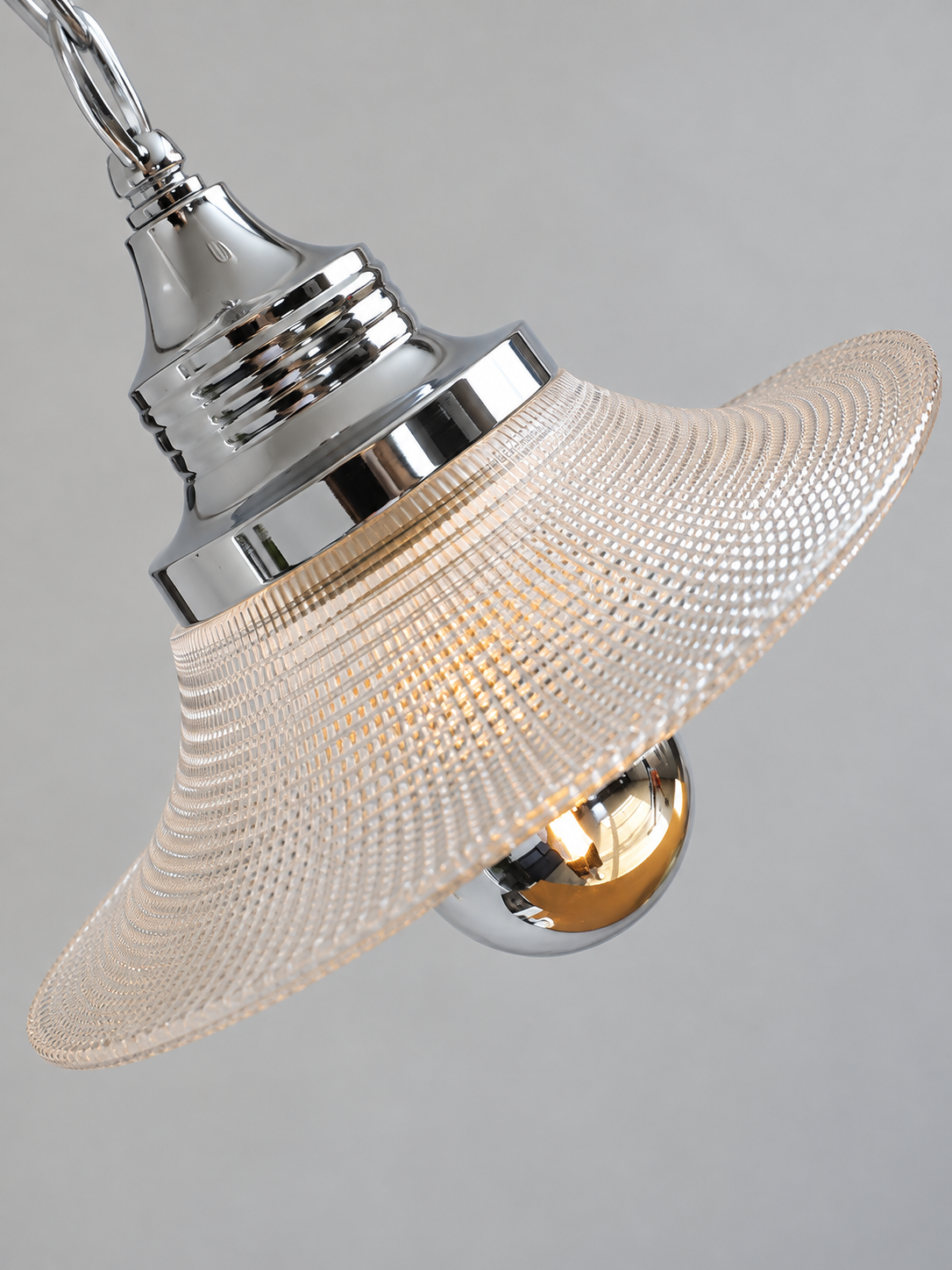 Close-up of the Clear Arc textured glass shade and chrome socket cover