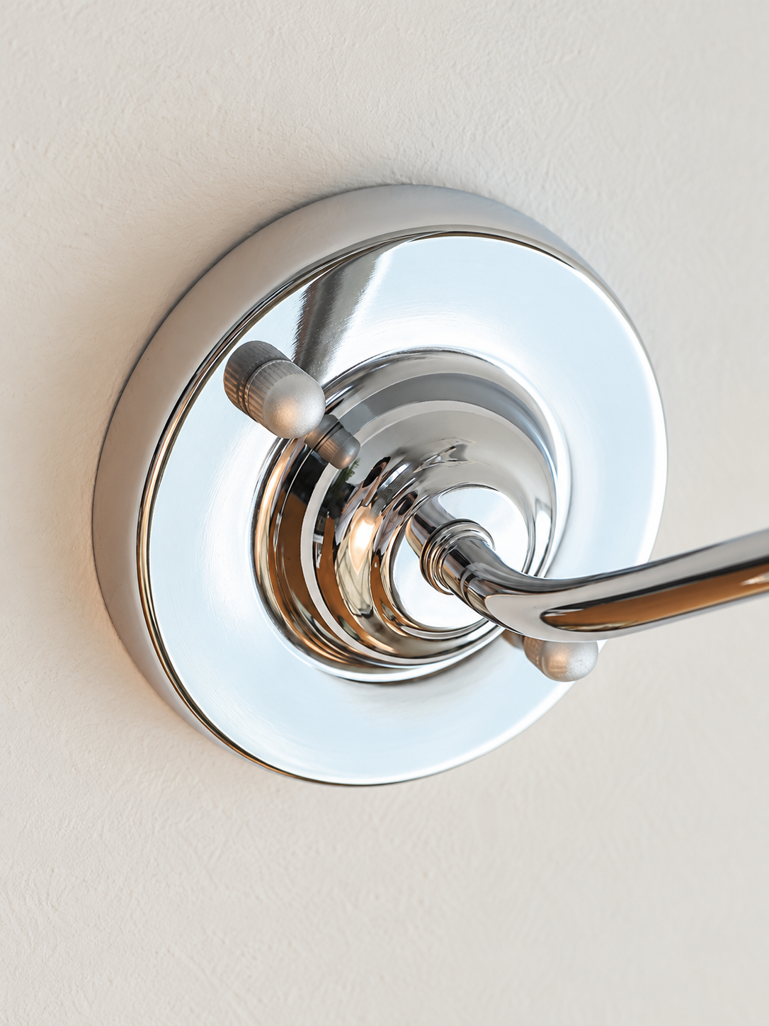 Clear Arc polished chrome wall plate and curved arm detail