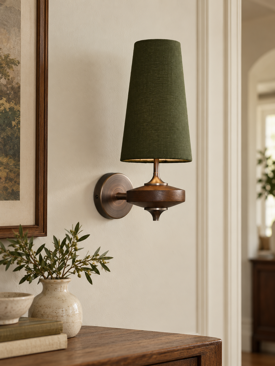 Green tapered fabric wall sconce with brown wood and metal base