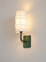 Side view of the curved copper arm and fabric wall-light shade
