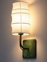 Warm light through the contoured fabric shade and its ribs