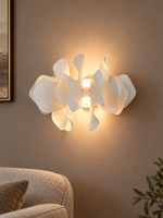 Ceramic Drift wall sconce casting a warm halo in an evening sitting room