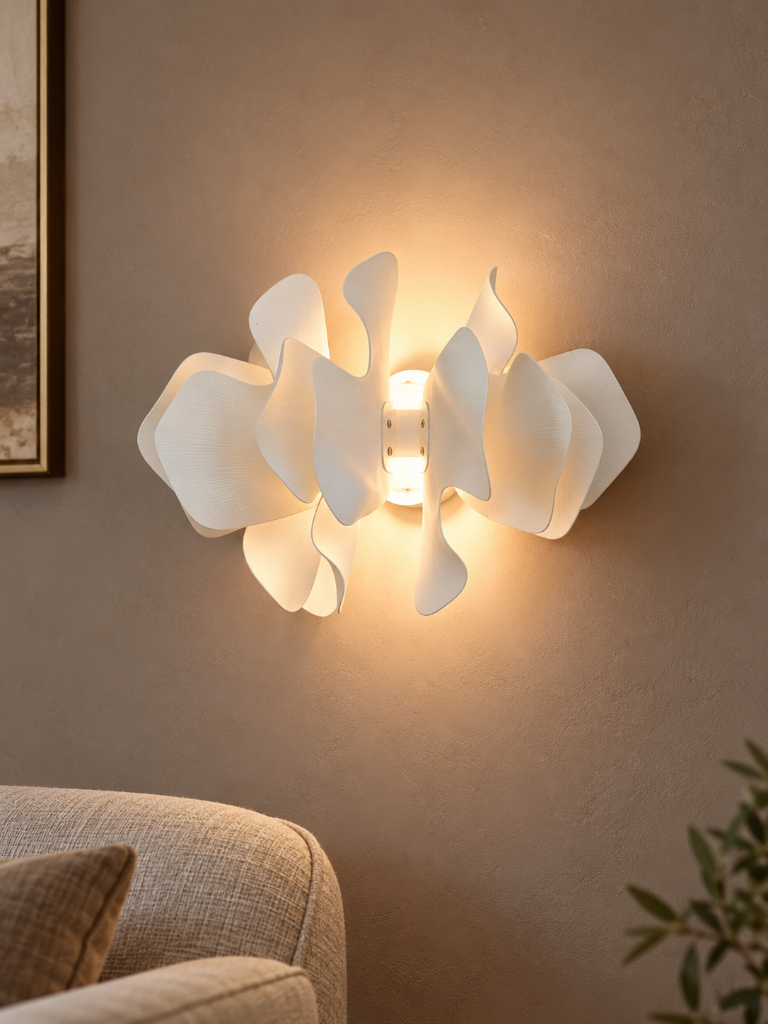 Ceramic Drift wall sconce casting a warm halo in an evening sitting room