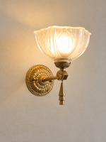 Copper-tone upward floral glass wall light with tiered decorative finial