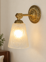 Copper-tone etched glass medallion wall sconce without drop ornament, shade facing down