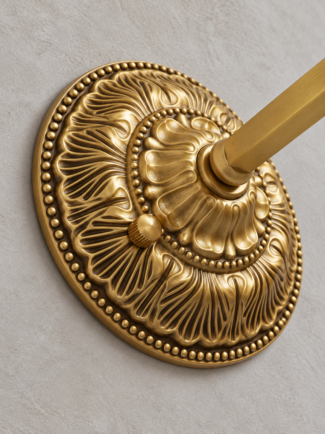Close-up of the copper-tone embossed floral medallion backplate