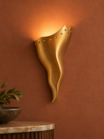 Copper tone brass wall sconce on terracotta wall