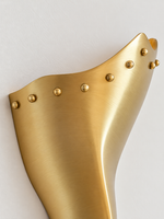 Copper tone brass shield and rounded rivet detail