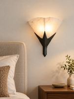Marble Fan Wall Sconce beside a linen headboard