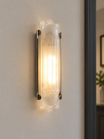 Scroll Edge wall sconce with antique-silver rails and softly lit pressed glass