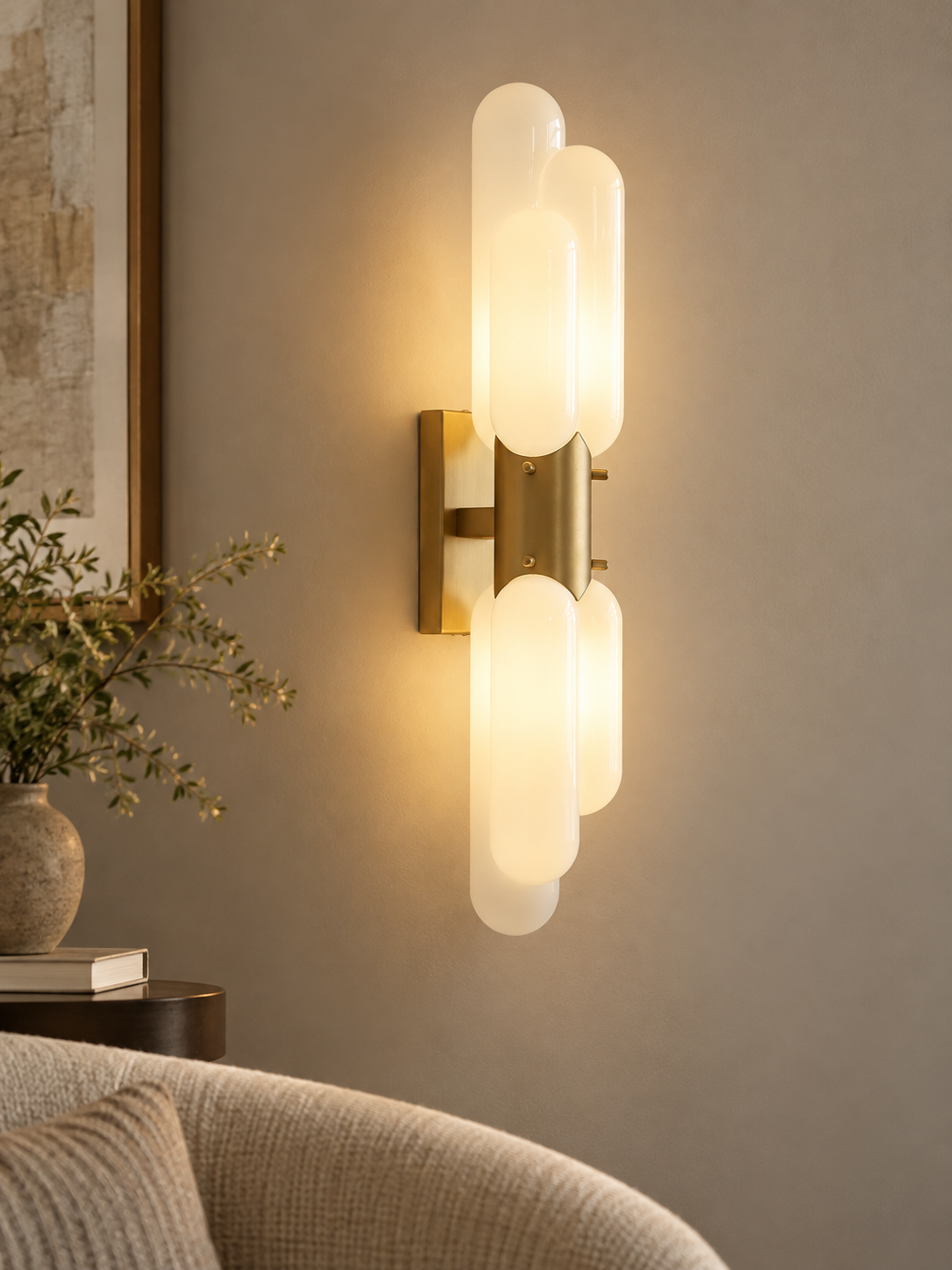Tiered opal glass wall sconce in Titanium Gold in a quiet reading corner