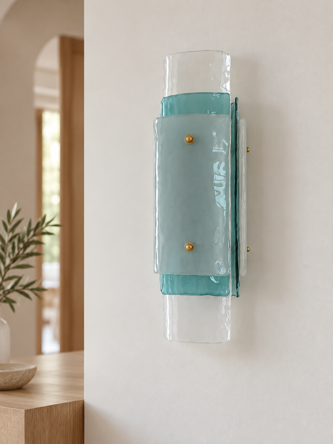 Layered Glass Wall Sconce in Blue, showing its aqua-tinted middle glass and pale front panel unlit