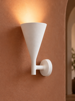 White plaster uplight on terracotta wall