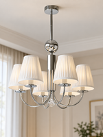 Six-light chrome chandelier with white pleated shades