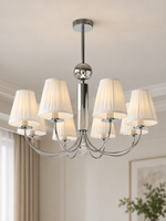 Eight-light chrome chandelier with white pleated shades