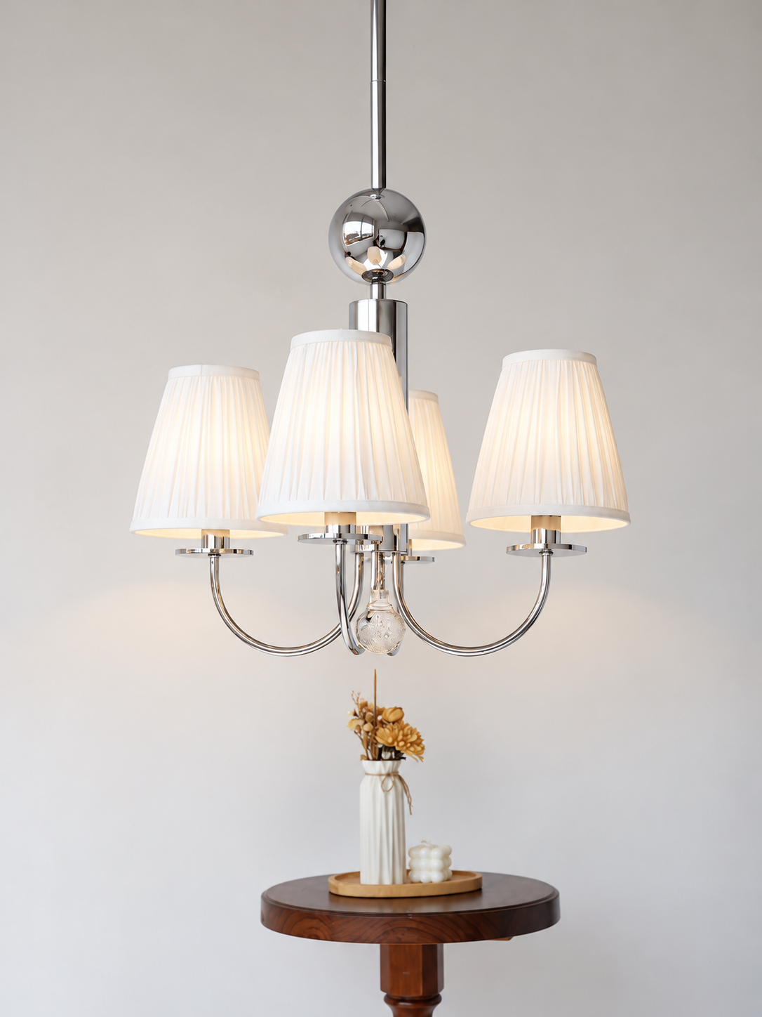 Four-light chrome chandelier with clear decorative drop