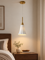 Fluted Ceramic Mini Pendant in Copper Tone and White above a walnut bedside table
