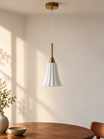 Copper-tone and white ceramic mini pendant with a slim stem over a walnut dining table